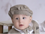 Linen flat cap for a boy with a beige herringbone pattern