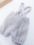 Elegant linen baptism shorts with suspenders for a boy with pleats